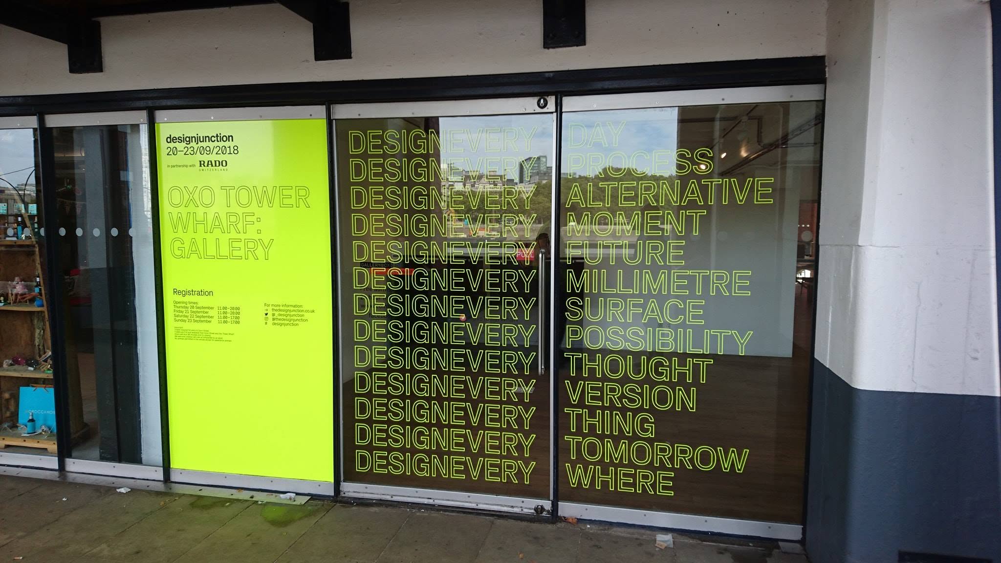 Designjunction event branding and vinyl lettering applied across glass panels
