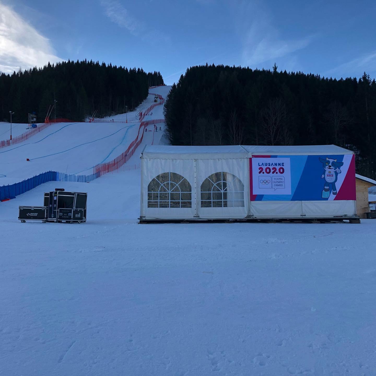 Winter Youth Olympic Games branding installed beside a ski course